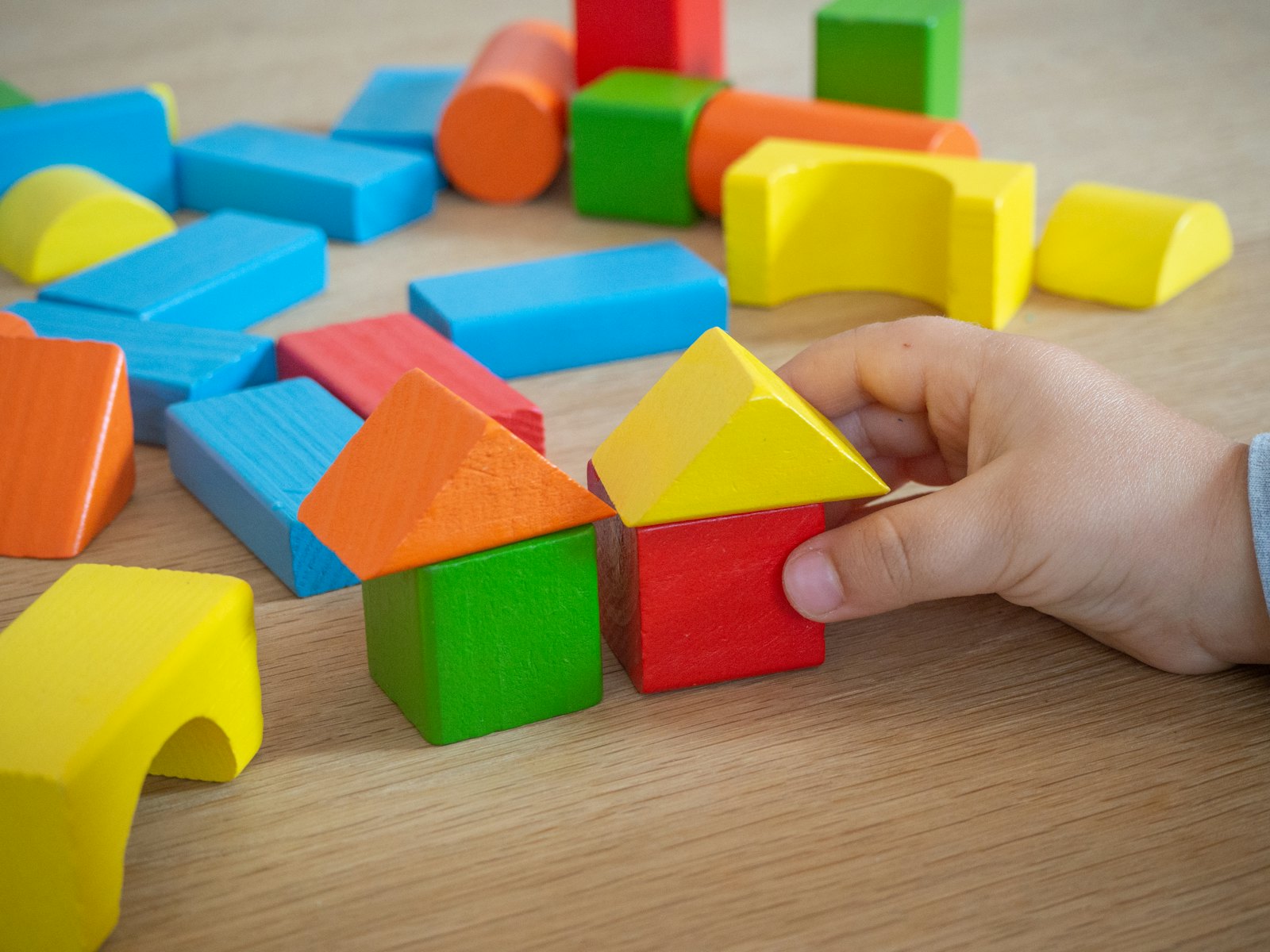 A child building with wooden blocks